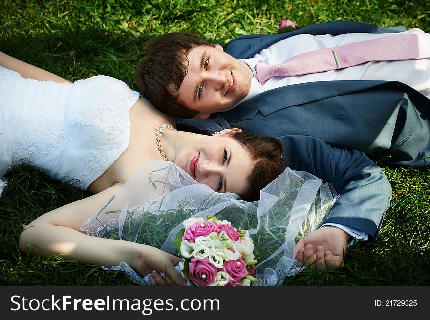 Happy bride and groom at wedding walk on grass in park. Happy bride and groom at wedding walk on grass in park