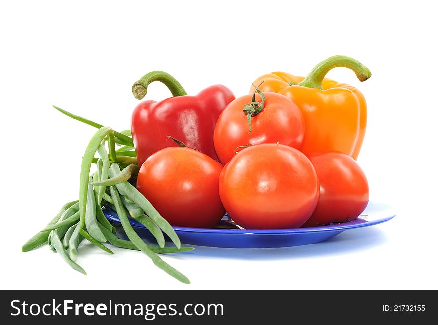Vegetbles on blue plate, on a white background. Vegetbles on blue plate, on a white background