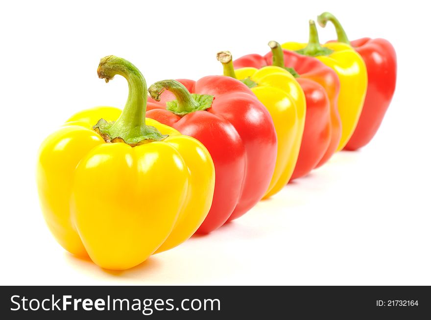Red and yellow paprika peppers   on a white background