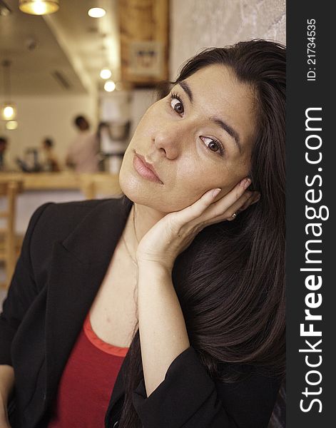 Pretty brunette with red shirt and dark coat