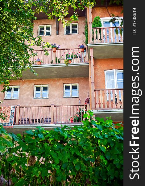 Facade of old building in Old town of Warsaw, with comfortable balconies and flowers in pots. Facade of old building in Old town of Warsaw, with comfortable balconies and flowers in pots