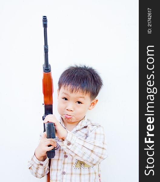 Lonely asian boy with gun in his arm