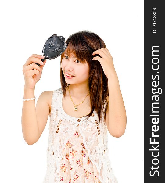 Happy cute girl looking at mirror on white background