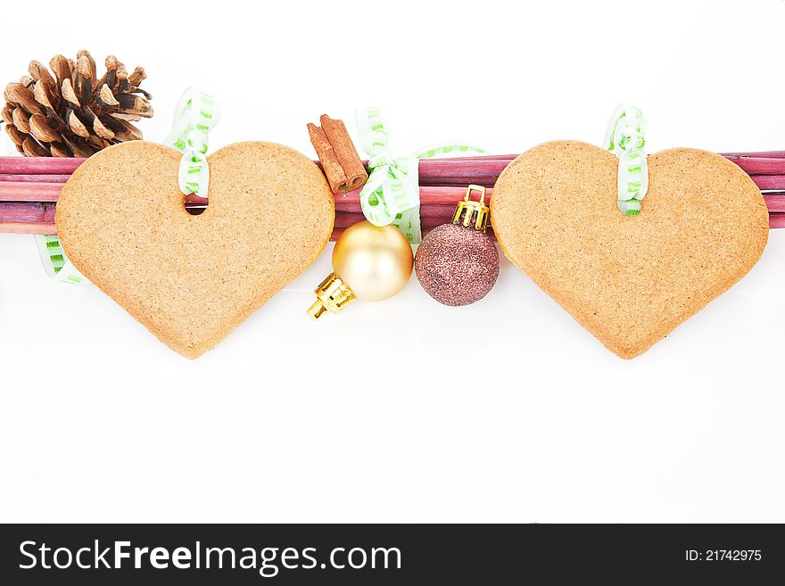 Christmas still life with heart shaped gingerbread, cinnamon, pine cone and copy space. Temporary christmas concept. Christmas still life with heart shaped gingerbread, cinnamon, pine cone and copy space. Temporary christmas concept.