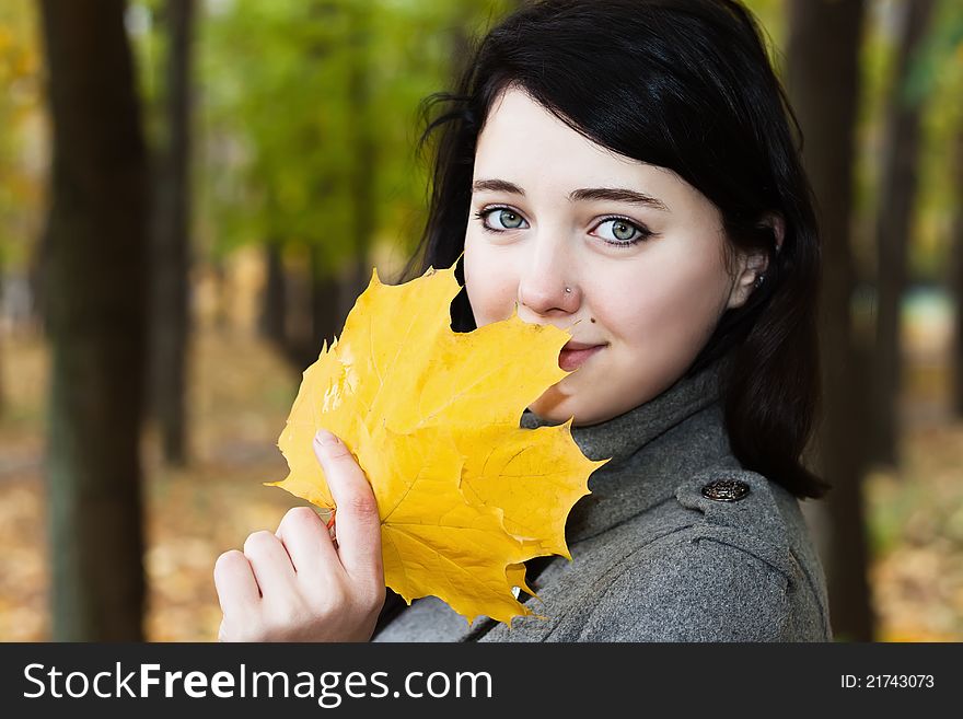 Woman Portrait With Autumn Leaf