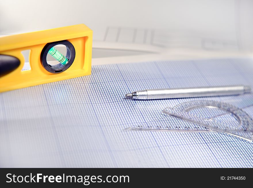 Pencil, graph paper, water level and ruler. Workplace Designer. Shot with shallow depth of field. Selective focus. Pencil, graph paper, water level and ruler. Workplace Designer. Shot with shallow depth of field. Selective focus.