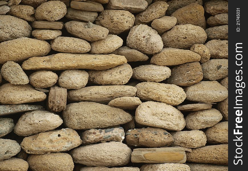 Wall background made of sea washed round stones. Wall background made of sea washed round stones