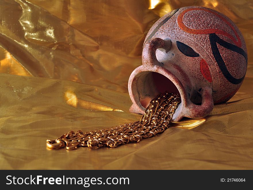 Vase with jewelry over gold background. Vase with jewelry over gold background
