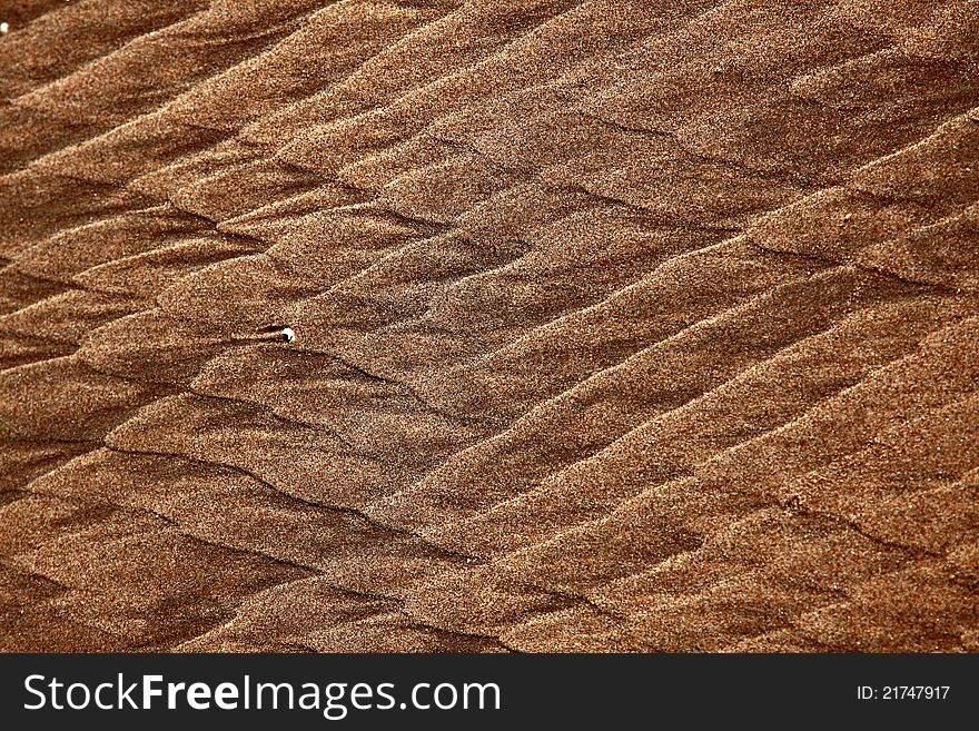 North Sea beach with flowing pattern in the sand. North Sea beach with flowing pattern in the sand