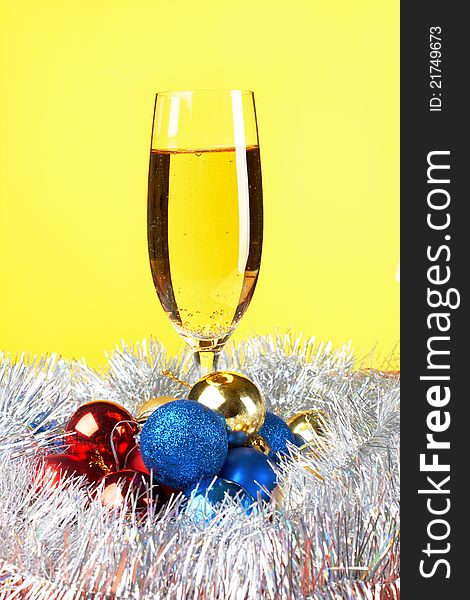 Christmas and New Year decoration- balls, glasse of champagne .On yellow background