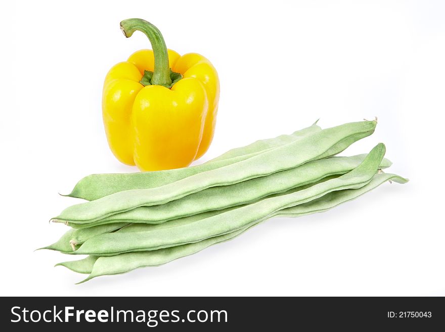 Green beans and yellow pepper on white background