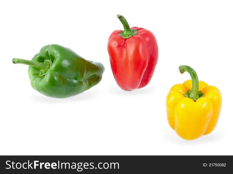 Yellow, green and red peppers on a white background