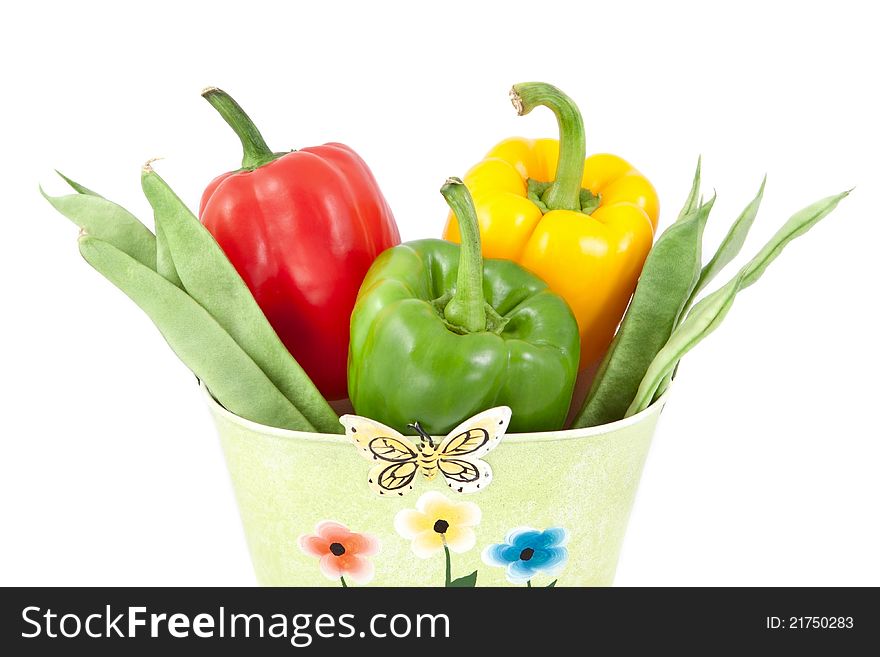 Green beans with yellow, green and red peppers on a white background