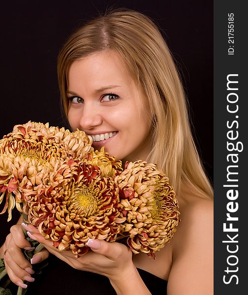 Romantic image of a young woman with yellow chrysanthemums.