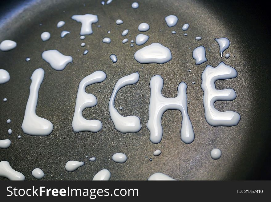 Word leche written with milk