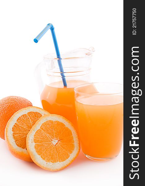 Orange juice in jug and glass with pipe over white