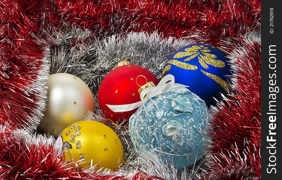 The shot was taken using different Christmas balls and background of white and red decorative garland. The shot was taken using different Christmas balls and background of white and red decorative garland