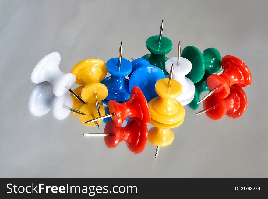 Multicolor buttons with reflections on grey background