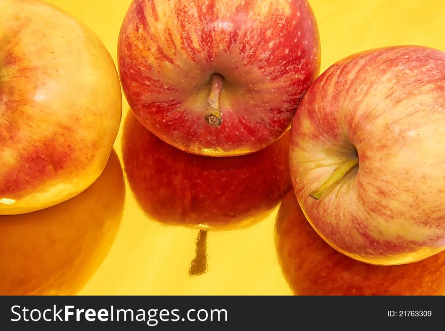 Apples with reflections on gold background