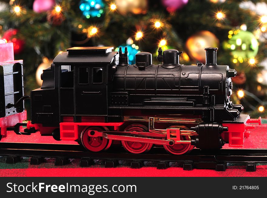 Christmas tree with decoration objects and toy train in the front. Christmas tree with decoration objects and toy train in the front.
