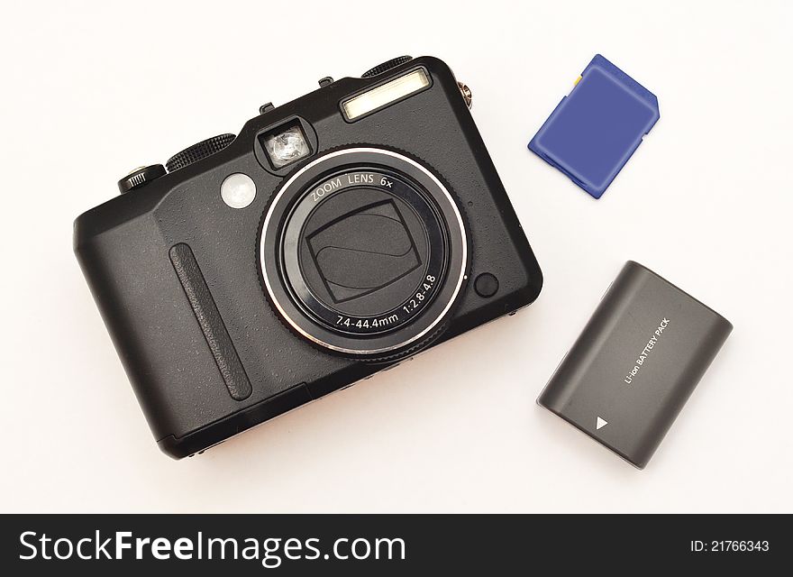 Compact digital camera with memory card and battery pack