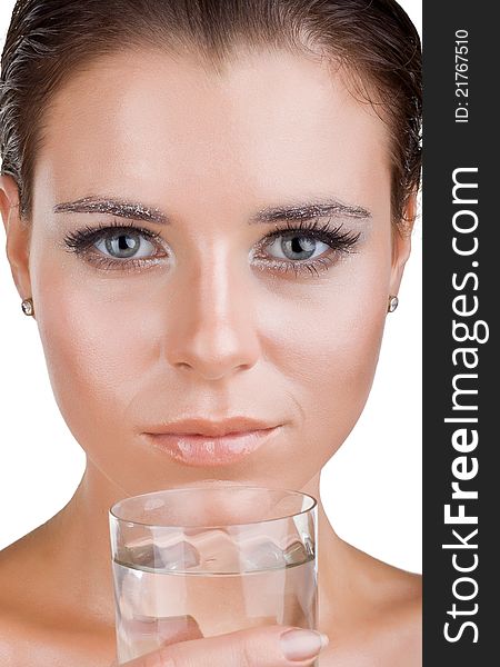 Close up of beautiful woman's face, she is holding a glass of clean water, isolated on white background