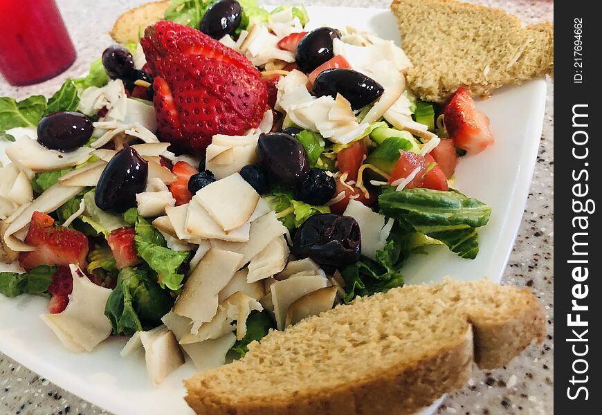 Gourmet style salad, with kalameta olives, fruit, and more