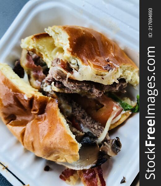 Messy mushroom, swiss bacon burger on a roll