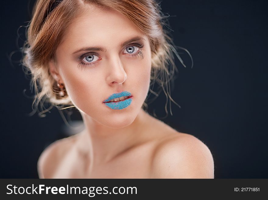 Studio portrait of attractive young woman on dark background