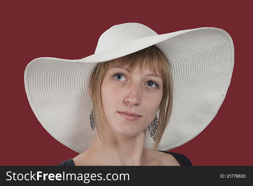 Pretty girl with white hat isolated on red background. Pretty girl with white hat isolated on red background