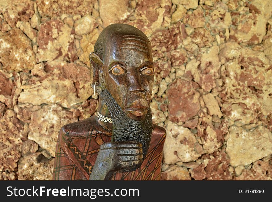 African wooden sculpture of a representative of an old man. African wooden sculpture of a representative of an old man