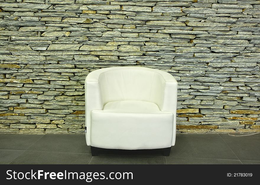 White chair and stone wall