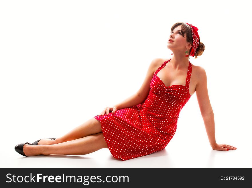 Young girl in a red dress, sitting on the floor, isolated on white background. Young girl in a red dress, sitting on the floor, isolated on white background.