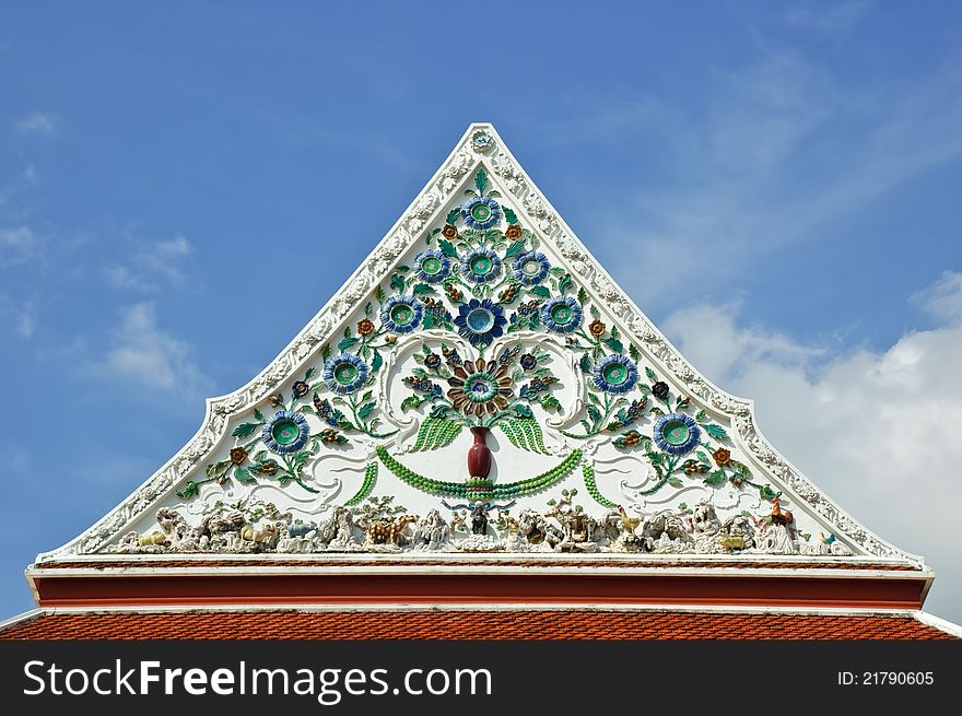 Detail of ceramic ornately decoration at temple roof in Thailand. Detail of ceramic ornately decoration at temple roof in Thailand