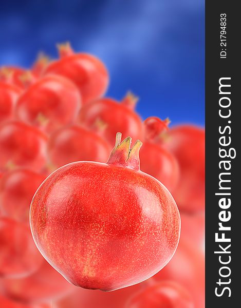 Ripe pomegranates on a sky blue background. Ripe pomegranates on a sky blue background