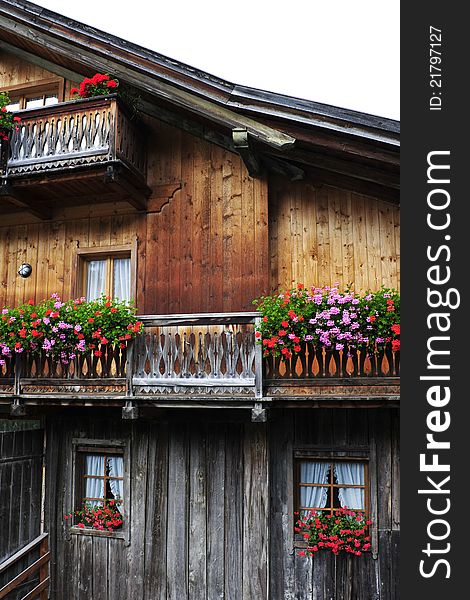 Typical alpine house with balcony and flowers. Typical alpine house with balcony and flowers.