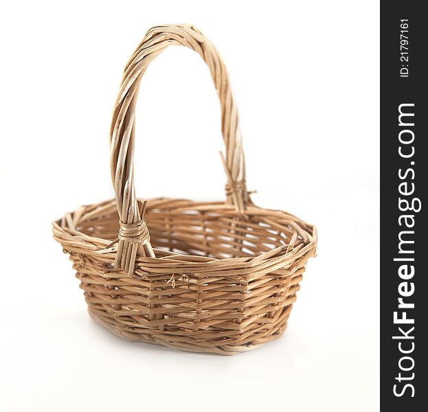 Brown wicker basket on the white background