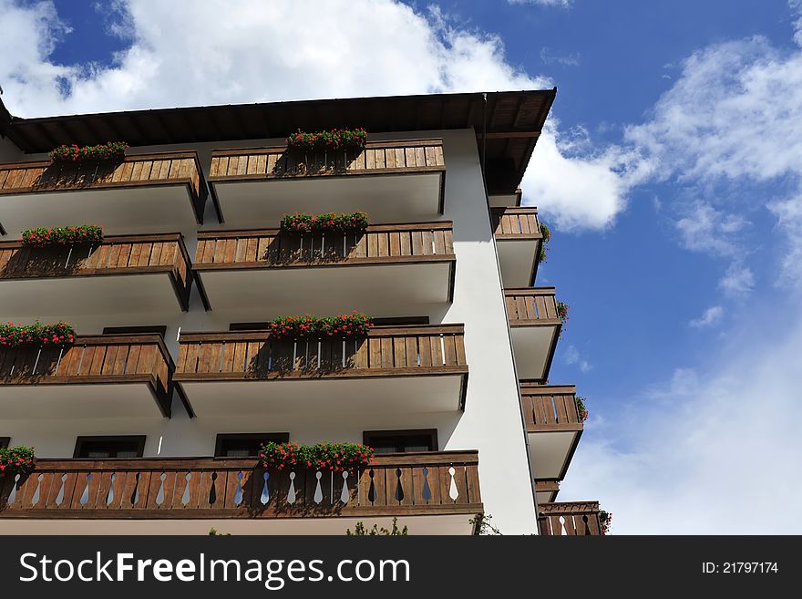 Alpine hotel facade with balcony flowers in Italian Dolomites. Alpine hotel facade with balcony flowers in Italian Dolomites.