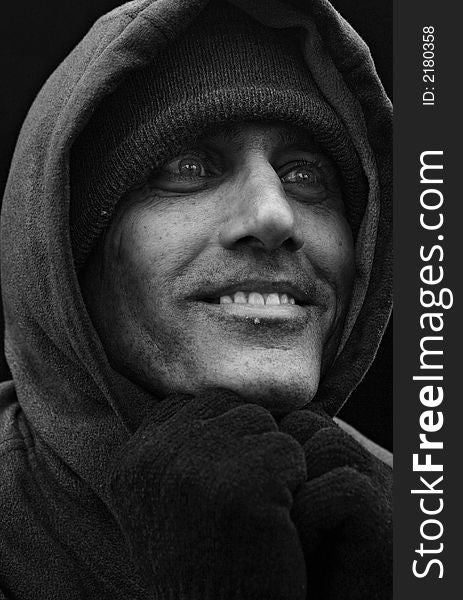 Close up black and white portrait of urban man looking to the side with big smile. Close up black and white portrait of urban man looking to the side with big smile
