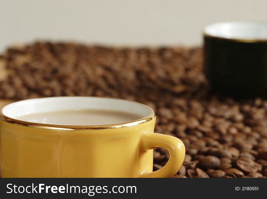 Yellow cup and grains of coffee. Yellow cup and grains of coffee