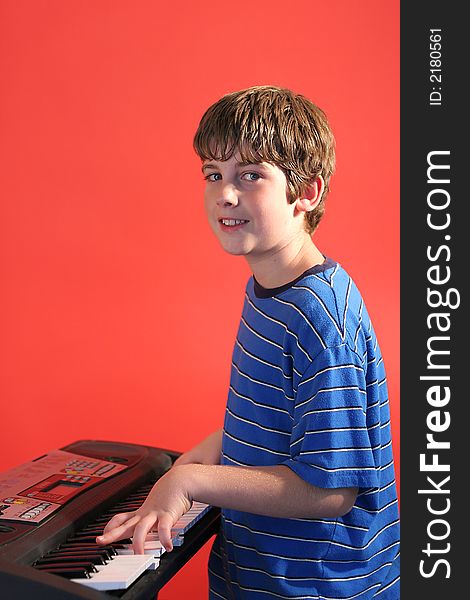 Photo of a boy on keyboard right vertical
