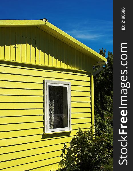 Small summerhouse painted in yellow. Small summerhouse painted in yellow