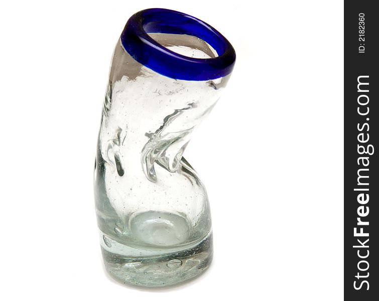 A hand made bent shot glass over white.