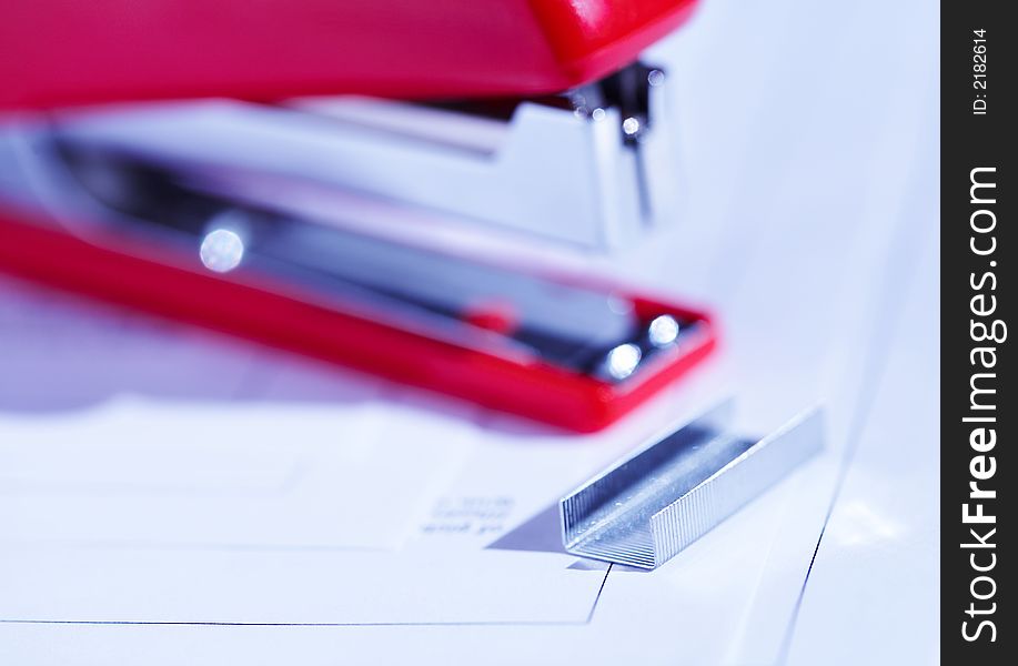 Red stapler with a bunch of staples. Red stapler with a bunch of staples