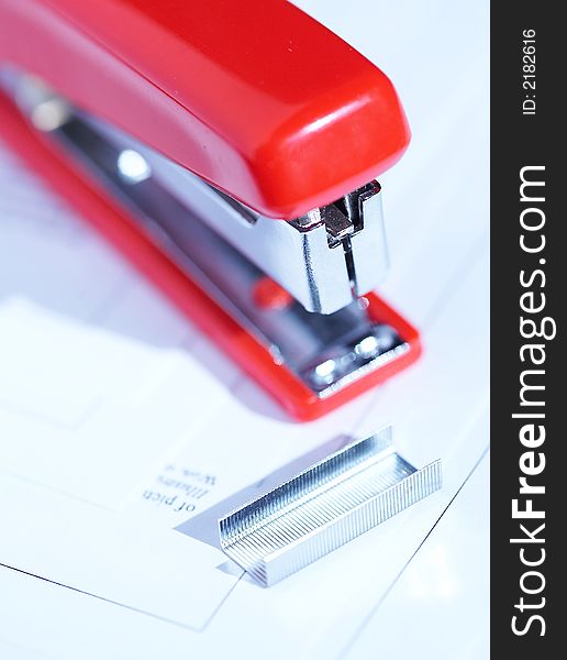 Red stapler with a bunch of staples. Red stapler with a bunch of staples