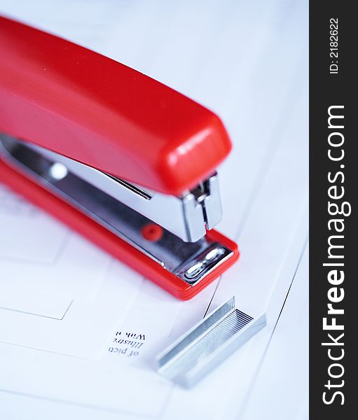 Red stapler with a bunch of staples. Red stapler with a bunch of staples