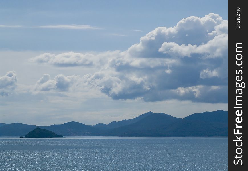 Photo about sea, coastline and sky with white clouds. Photo about sea, coastline and sky with white clouds