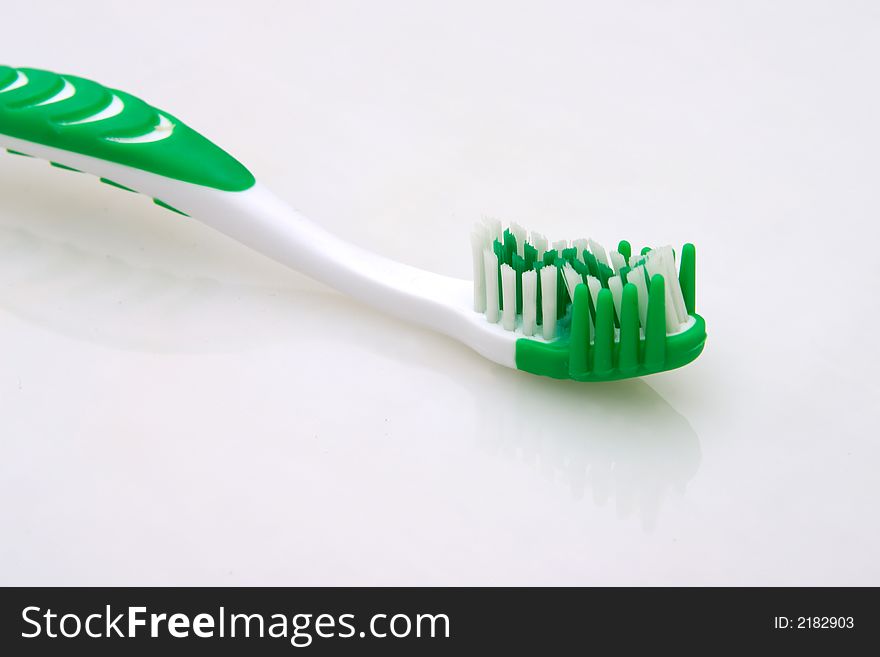 Green toothbrush head detail isolated