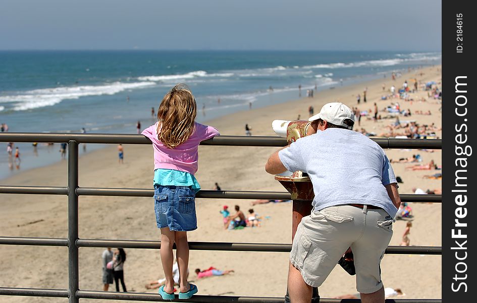 Father and Daughter Examine Coast Through Telescope. Father and Daughter Examine Coast Through Telescope