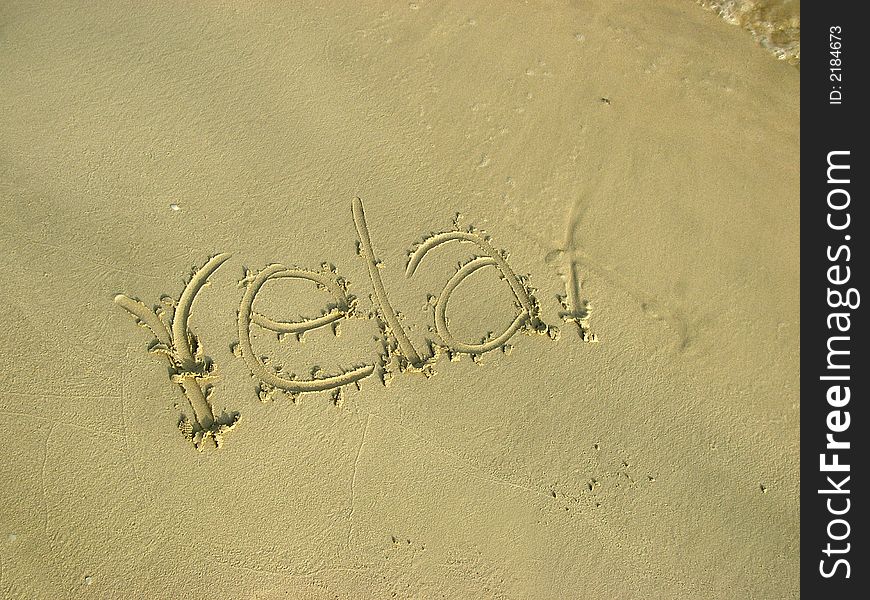 Relax written on the beach sand. Relax written on the beach sand